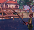 A character from the side, in green clothes, and styled dreadlocks holds a fishing rod that has a black body. No bobber is visible. The background features a lake and dock, leading up to a building in Kilima village.