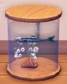 An in-game look at Oily Anchovy in a fish tank.